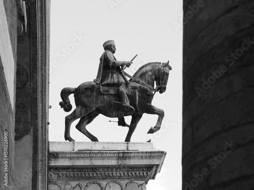 The equestrian statue of Niccolò III d'Este, Marquis of Ferrara, a city in Northern Italy. Black and white photo.