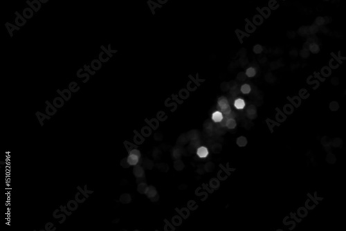 White gray blurred bokeh lights on black background. Glitter sparkle stars for celebrate. Overlay for your design