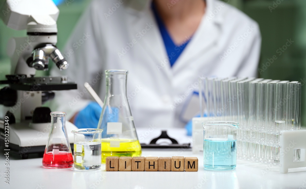 Fototapeta premium A skilled scientist analyzes lithium in a lab, showcasing glassware and tools for precise measurements