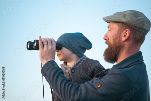 Happy father with son enjoying nature on sunny day
