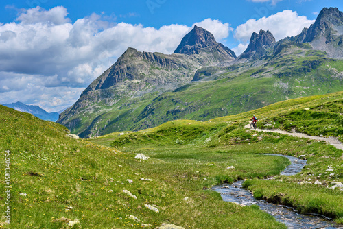 nice active senior woman riding her electric mountain bike in the silvretta mountain range near Gaschurn, Tyrol, Austria