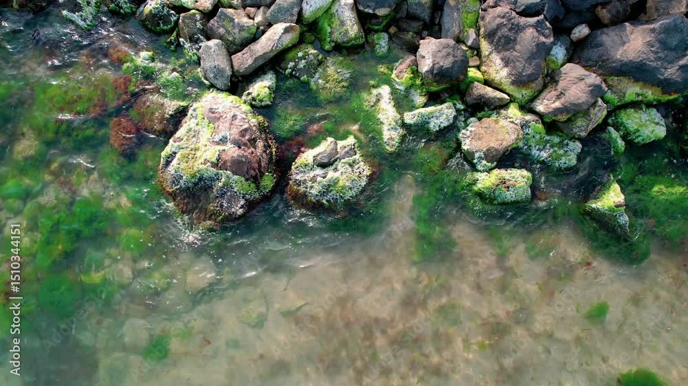 Rocky coastline, first person view of the stones in a sea, stones and rocks view, textures video background.