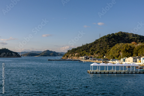 Ferry Approaching Naoshima Island during Tranquil Evening Light, Setouchi, Japan