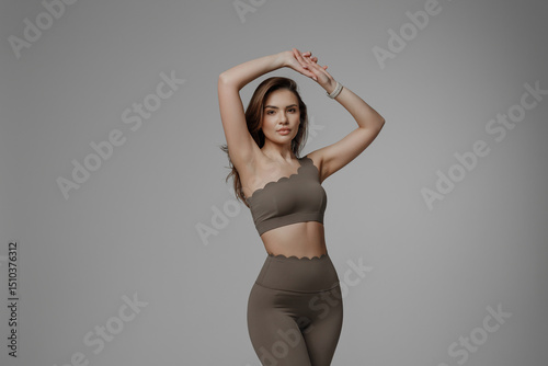Wallpaper Mural Stylish model showcases modern activewear in studio setting during a fashion photoshoot Torontodigital.ca