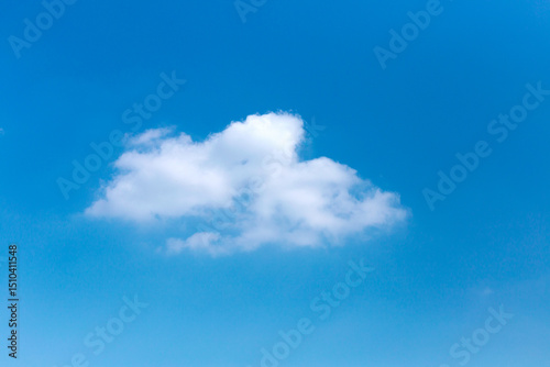 Minimalist Single White Cloud Formation Against Clear Blue Sky Backdrop