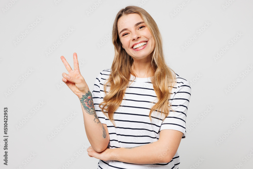 Young smiling cheerful happy fun Caucasian woman she wear striped t-shirt casual clothes showing victory sign look camera isolated on plain solid white background studio portrait. Lifestyle concept. Young smiling cheerful happy fun Caucasian woman she wear striped t-shirt casual clothes showing victory sign look camera isolated on plain solid white background studio portrait. Lifestyle concept.