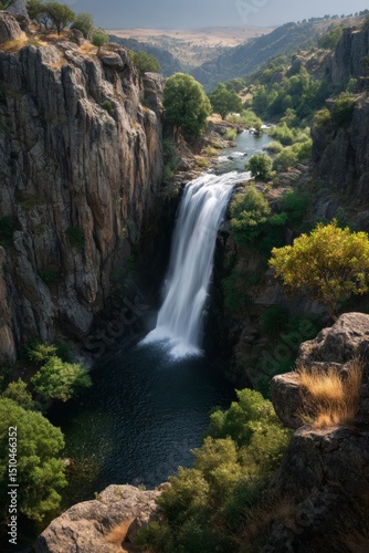 Breathtaking view of a cascading waterfall in a rugged mountain landscape.