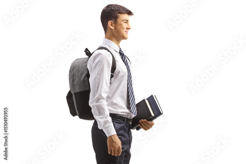 Male teen student in a school uniform holding books