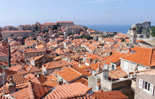 Wallpaper Mural Panoramic view of orange-tiled rooftops in a historic European coastal city by the sea—perfect for travel, tourism, or cultural presentations and editorial content Torontodigital.ca