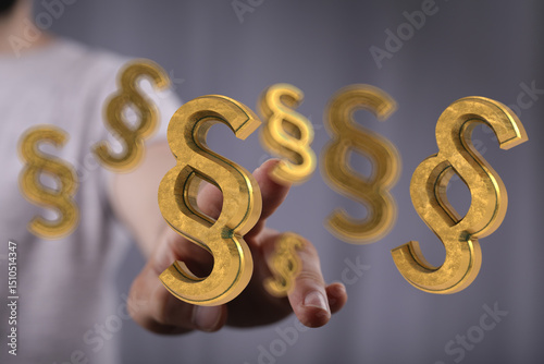 Wallpaper Mural Hand reaching for 3D golden paragraph symbols.  Legal concept. Torontodigital.ca