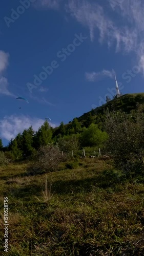 Paragliders Flying Above Green Hills of Puy de Dome volcano