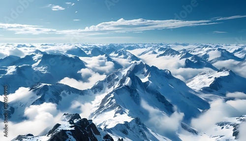 A vast panorama of rugged snow covered peaks breaking through a sea of clouds under a crisp blue sky with cold clean air