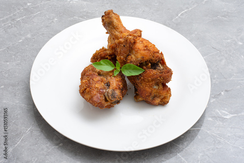 Traditional indonesian fried chicken with spices ayam rempah photo