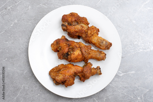Traditional indonesian fried chicken with spices ayam rempah photo