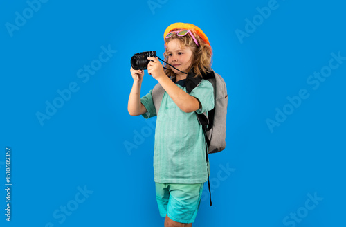 Child travel with travel bag. Child with suitcase dreams of travel, adventure, vacation. Studio kids portrait.