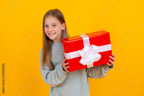 Teenager girl hold gift box. Child holding gift box in Christmas or birthday. Girl with giftbox for mothers day. Portrait of a little girl with a gift on isolated background. Birthday, presents gift.