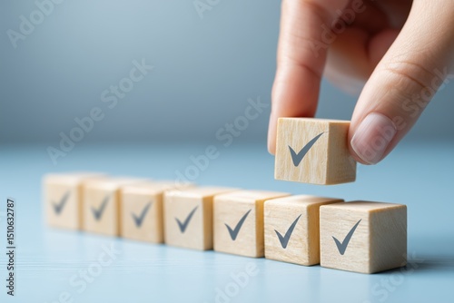 A hand placing a wooden block with a checkmark among other blocks, symbolizing task completion and organization.