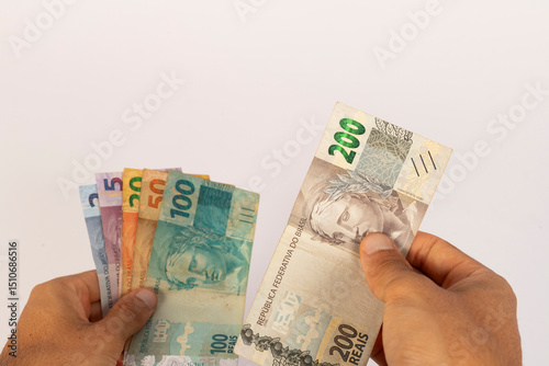 Hands of a Man Holding Brazilian Bank Notes Reais ready to pay