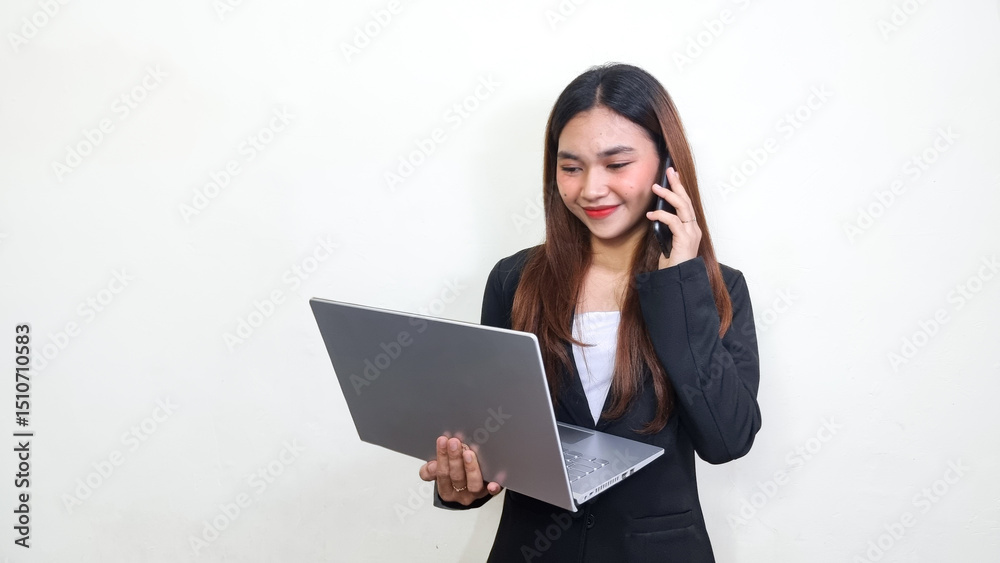Beautiful and successful asian business woman. Office woman in black suit looking at laptop with serious face and receiving call from smartphone. Knowledgeforall. Beautiful and successful asian business woman. Office woman in black suit looking at laptop with serious face and receiving call from smartphone. Knowledgeforall.