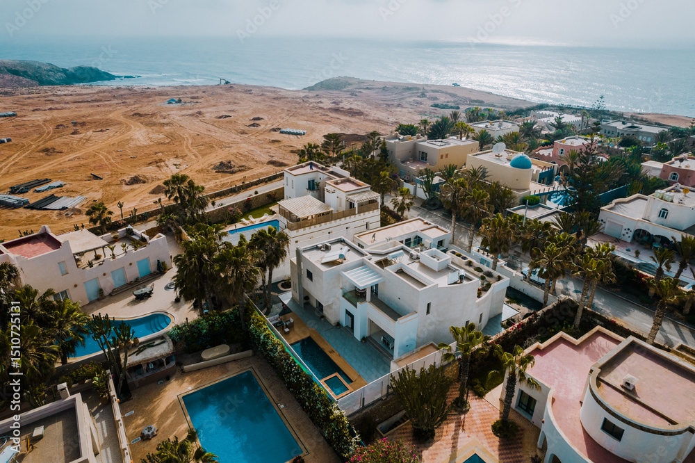 Fototapeta premium Luxury Coastal Villas Surrounded by Palm Trees in Mirleft Morocco Morocco May 29,2025 