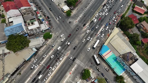 Aerial view of traffic intersection in Bangkok Thailand with cars and urban street