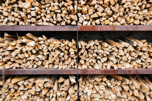 background of chopped firewood for barbecue stacked on shelves