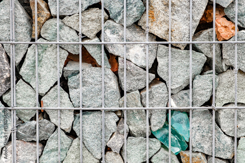 rubble stones behind metal grate close-up background