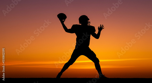 Silhouette of a football player throwing the ball against an orange and purple sunset background sky