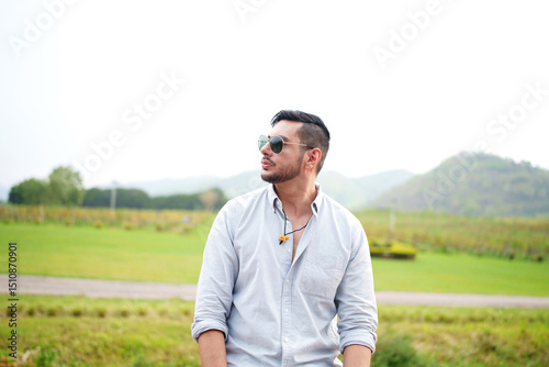 Handsome man entrepreneur standing in front organic vineyard.