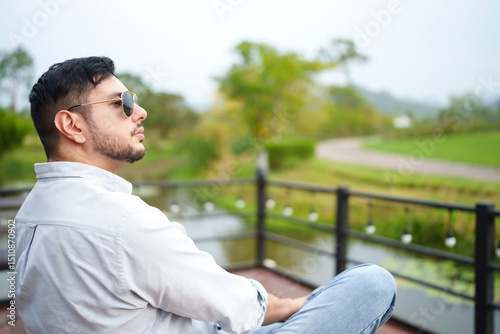 Handsome man entrepreneur looking at his organic vineyard.