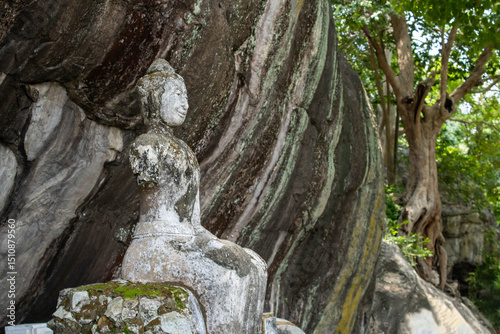 Ancient religious site of Buddhism on a cliff hundreds of years old, black and white, made from laterite.