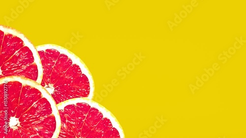 Abstract Grapefruit Slices Rotating Seamless Animation On Yellow Background 4k	