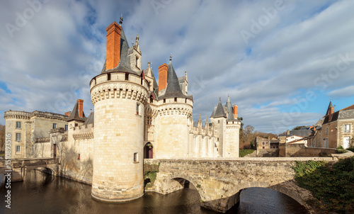 Dissay castle, near Poitiers, in France, full view under the sun, sometimes referred as Sleeping Beauty castle, with moat and bridge, now rehabilitated in a luxury hotel