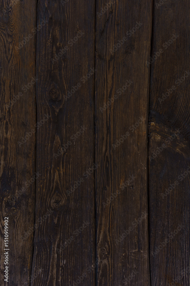 Fototapeta premium Dark brown wooden planks form a wall. Gloomy atmosphere. Natural wooden background.