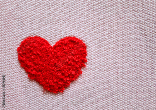 Red Knitted Heart on Fabric Background