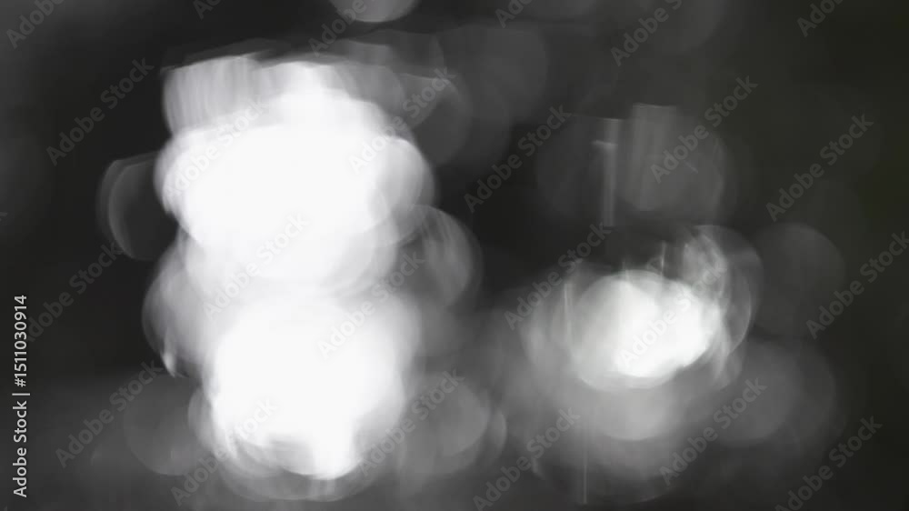 Tokyo, Japan - May 30, 2025: Bokeh of Heavy rain falling on a stone pavement in the night
