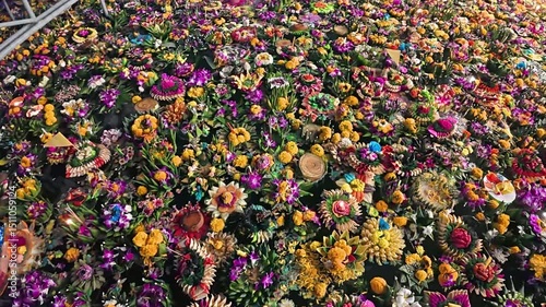 Colorful floating flower decorations in Phuket, showcasing a festive atmosphere with vibrant flowers in a water-filled setting.