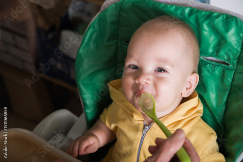Happy Baby Being Fed by Grandmother at Home