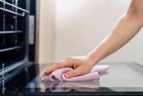 Cleaning the modern electric oven in a stylish kitchen for better functionality