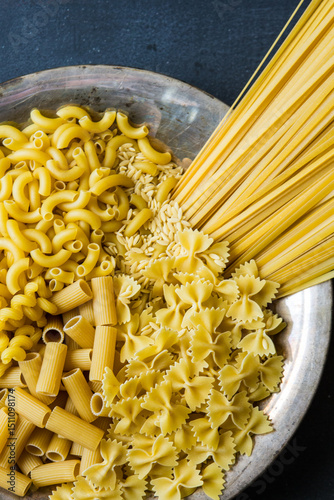 a variety of dry pasta in a bowl   photo