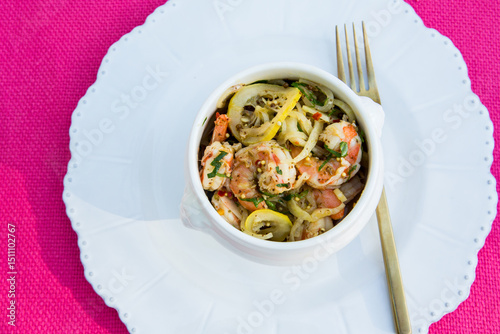 Shrimp and squash on a small ceramic serving bowl 
