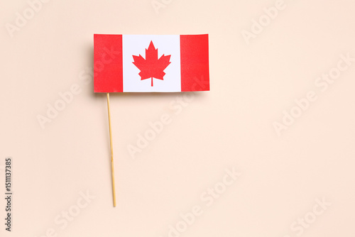 Paper flag of Canada on bei...