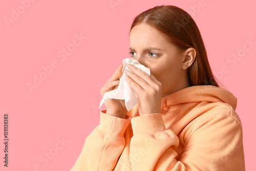 Allergic young woman sneezi...