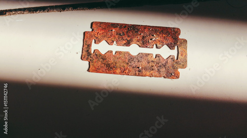 Close-up image of a rusty, old and unused razor blade	