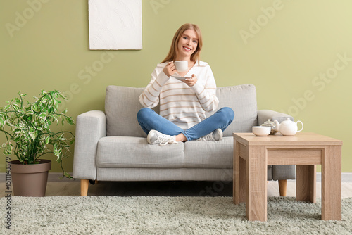 Young woman with cup of tea...
