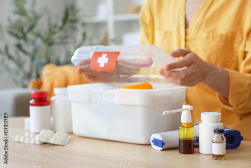 Woman with first aid kit an...