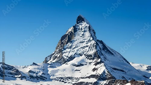 Dramatic High Angle View of Snow Covered Matterhorn Peak with Clear Blue Sky in European Alpine Landscape