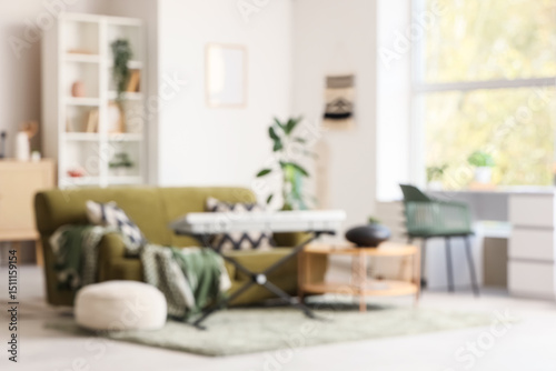 Blurred view of living room with sofa  glucophone and synthesizer