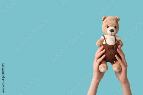 Hands holding baby toy on b...