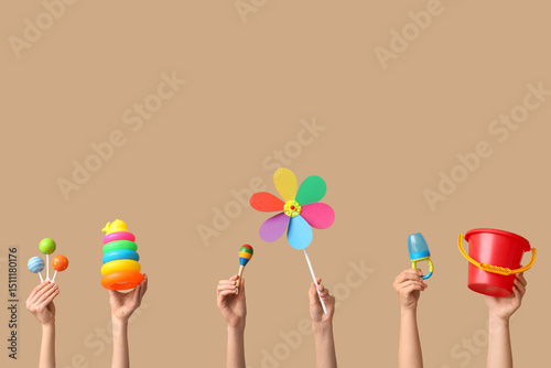 Hands holding baby toys on ...